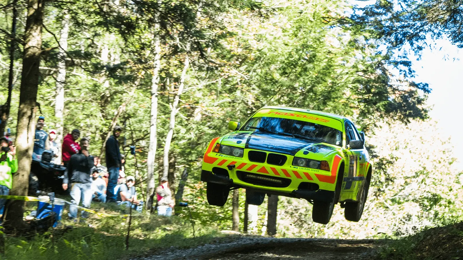 Matt Brandenburg's rally car airborne during competition on a forest stage